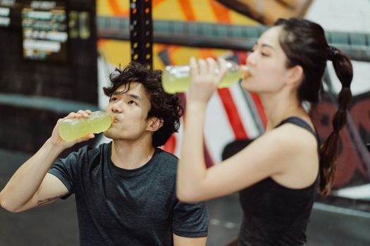 Runner recovering after exercise with water and electrolyte-rich drinks
