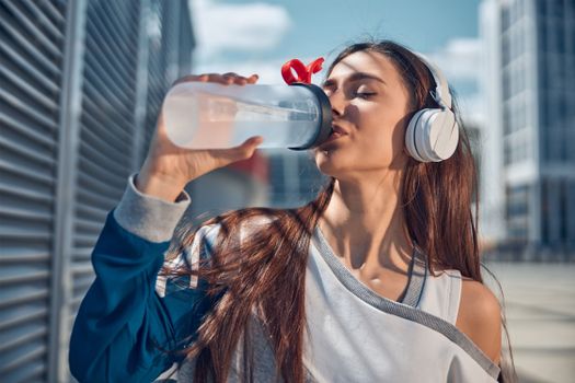 Person drinking water to recover from dehydration after exercise